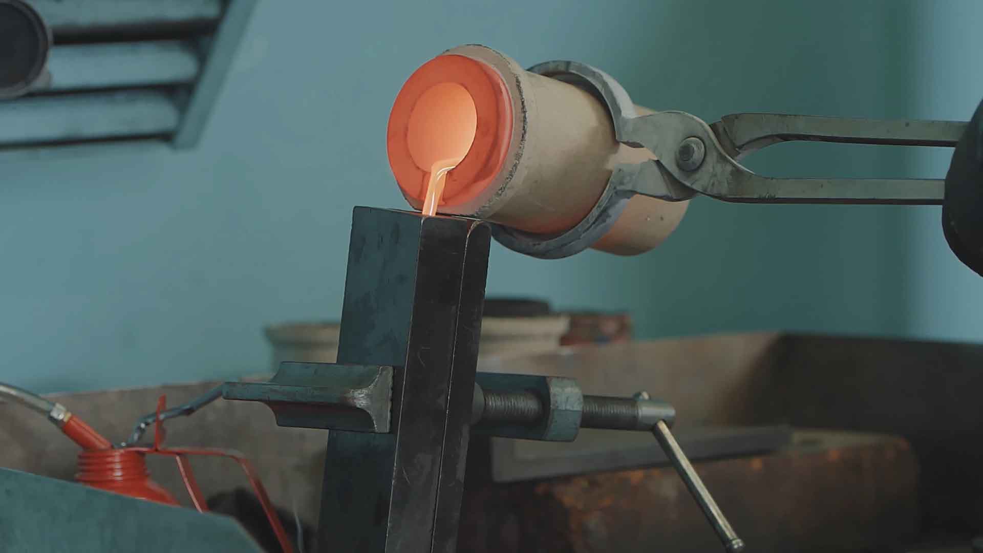 Molten gold being poured from a crucible during minting