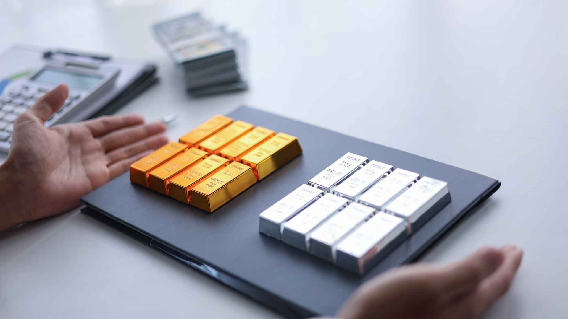 Gold and silver bullion bars arranged on a tray